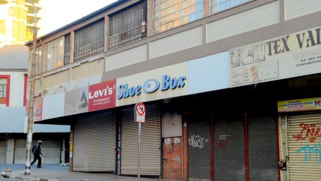 A man walks past closed shops after looting on September 2.