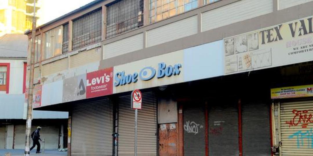 A man walks past closed shops after looting on September 2. 